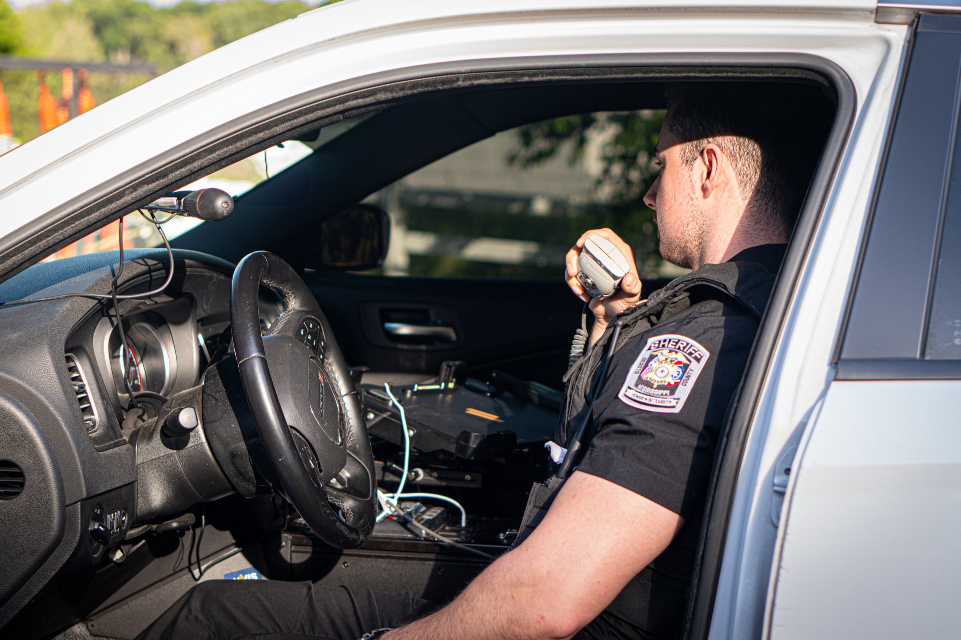 A DeSoto County deputy coordinating over the radio from a patrol vehicle